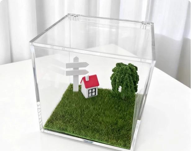 Hand-tended Sunny Lawn micro-scene with moss, signpost and tiny cottage